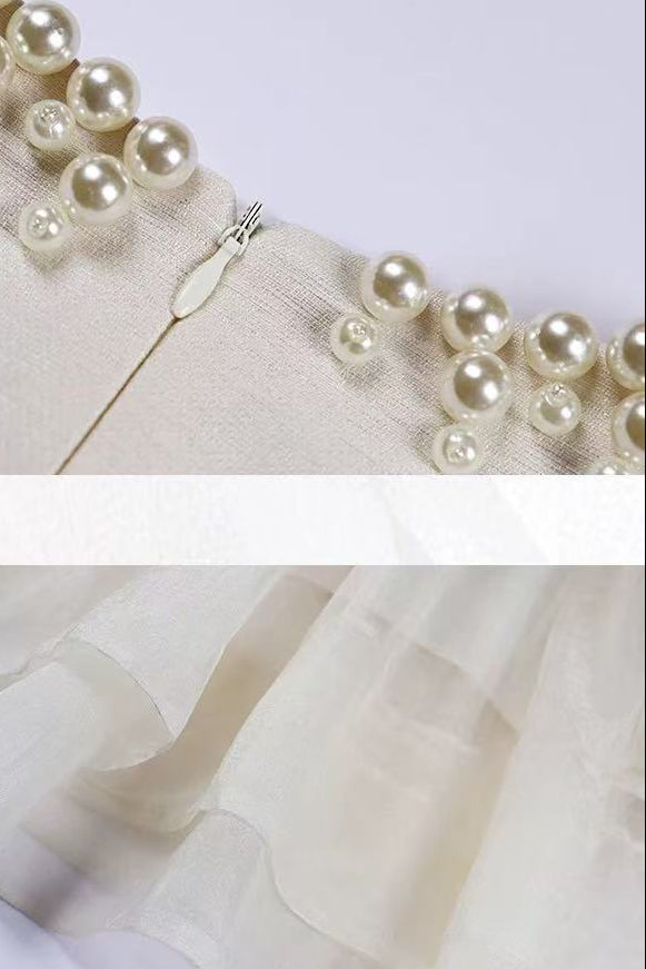 Pearl-trimmed fabric with a zipper and sheer fabric on a white background