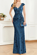 Woman wearing a blue sequin dress in an elegant room.